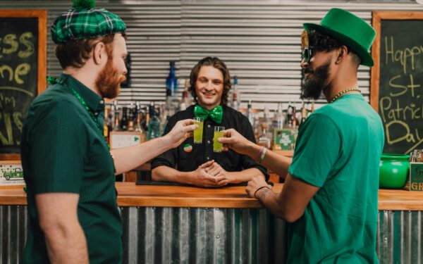 Featured image for the article "St. Patrick’s Day 2024: Ultimate Guide to Hosting Virtual Drinking Games Party". showing Two Men Celebrating Saint Patrick's Day