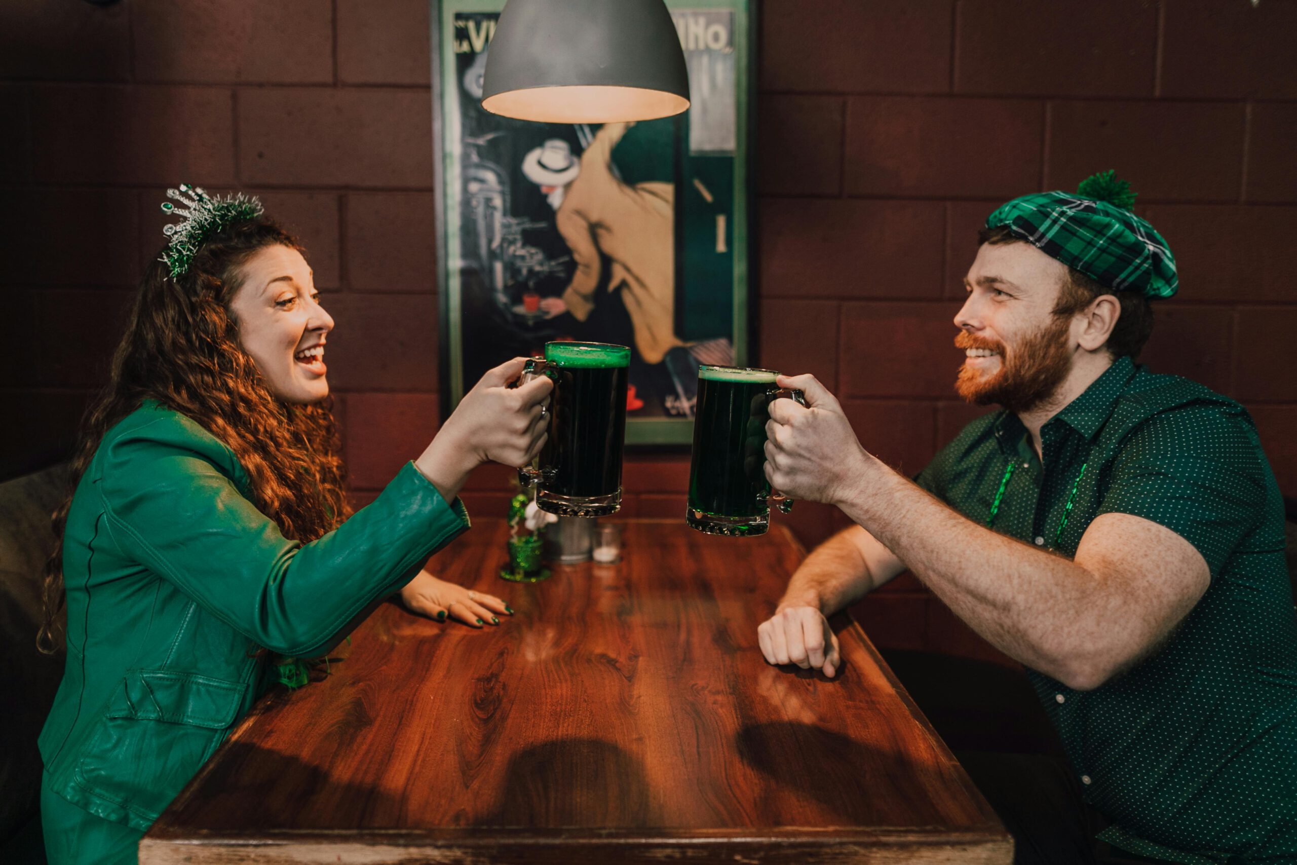 Illustration of Man and Woman Sitting at Table Drinking Green Beer for the article titled Mastering the Art of Hosting: Preparing for an Unforgettable St. Patrick's Day Party in 2024 photographed by RDNE Stock project