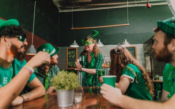 Featured image for the article "Valentine’s Day 2024 Countdown:  Your Ultimate Guide to Planning an Enchanting Cocktail Party". showing Woman in  a Green Dress Holding a Mug