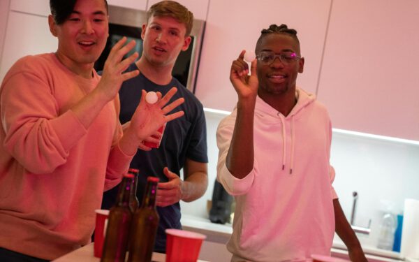 Featured image for the article "Easter Bunny Bash: Must-Try Interactive Drinking Games and Festive Entertainment Ideas for Easter 2024". showing Guys Playing Drinking Game